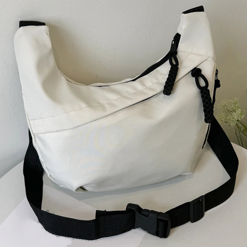 Neutral style tote bag with strap for carrying fitness items. New mini street-style handbag with shoulder strap. Lightweight and